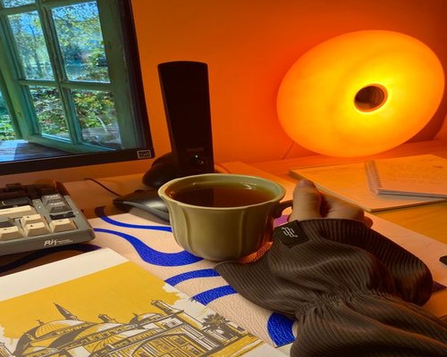 Natural light filtering through a window onto a comfortable desk setup