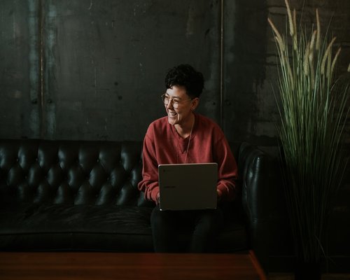 Person looking away from laptop to take a break